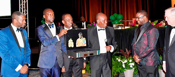 Richard Ofori Atta, Executive Chairman E ON 3 Group 3 ( second from left);  Alex Dadey, Executive Chairman of KGL Group ( third from left);  Nana Otuo Siriboe II, Juabenhene ( fourth from left) are joined by Andrew Achampong-Kyei ,Managing Director GLICO General Insurance ( left) to present the Otumfuo Commemorative Gold Coin to  Charles Ewing (right) Board Chairman of Memphis in May International Festival on behalf of Memphis City