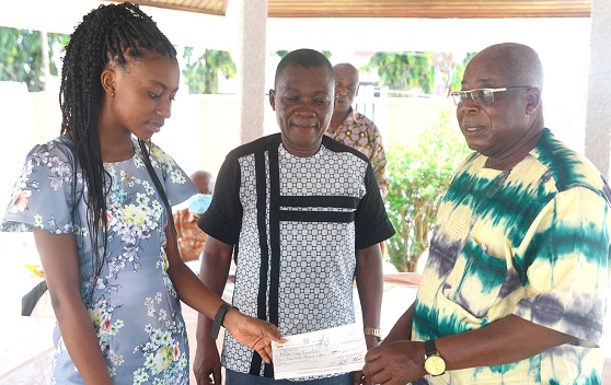 Naa Kuorkor Afutu (left), receiving a cheque from Dr Gabriel Ofoe Canacoo, chairman of the Board of Administrators. With them is Kojo Ayibor, headmaster of Ada Senior High School