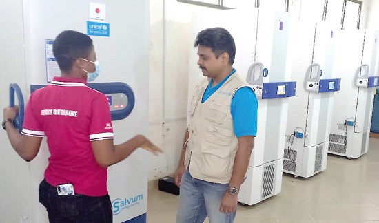  Gladys Siuetey, a Cold Room Manager, taking Dr Mrunal Shetye, Chief of Health and Nutrition, UNICEF Ghana, through the operations of the storage machine