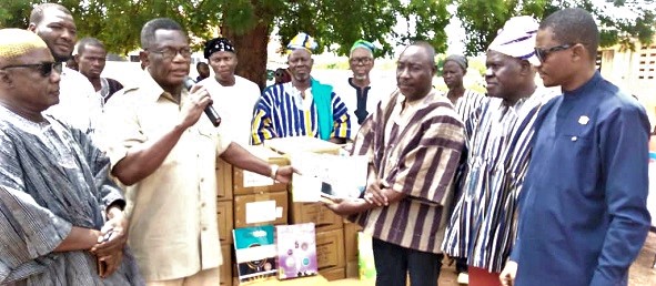Abubakar Sadiq Abdullah (2nd from left), Ghana's Ambassador to Kuwait, handing over the items to Sule Salifu (3rd from right), Head teacher of the school. Looking on is Ahmed Yakubu, the MCE for Sagnarigu, and other staff of the school