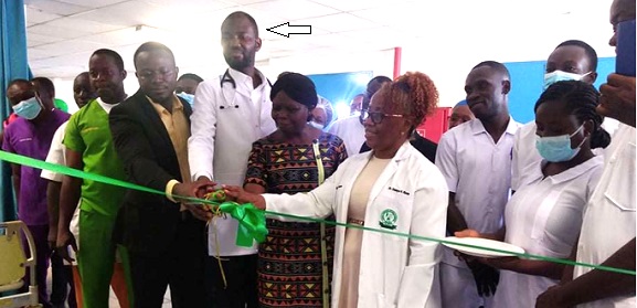 Dr Adam Atiku (arrowed), Medical Director of the Tamale Teaching Hospital, being assisted by other staff to cut  the ribon