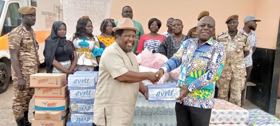 Henry Harding (left) presenting the items to Rev. Fr Martin Padi, the Deputy Director of Prisons, at the Nsawam Medium Security Prison