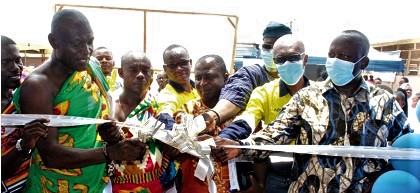 Nana Atta Tibo (left), the Adontenhene of the Terchire Traditional Council, being assisted by Agbeko Azumah (2nd from right), Director of Communications and External Relations, Newmont Ghana Gold Limited, and John Duti (right), Team Leader of Invest for Jobs, GIZ Ghana, to inaugurate the facility