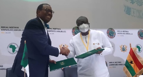 Ken Ofori-Atta (right), Minister of Finance, and Dr Akinwumi Adesina, President of the AfDB Group, exchanging copies of the agreement 