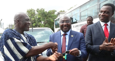   Dr Bawumia presenting the keys to one of the vehicles to Sulemanu Sumaila, the Headmaster of the Lambussie Community Day School.
