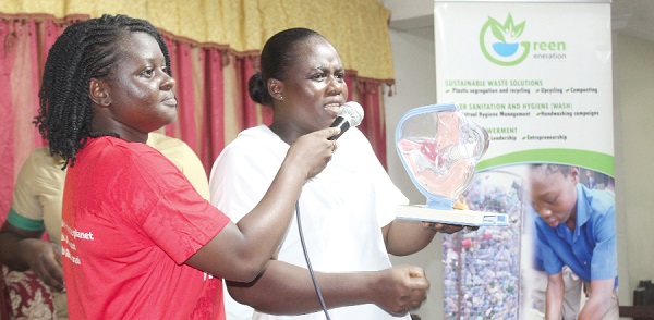 Christiana Bopoere (right), a nurse at  the Ussher Hospital, demonstrating how the menstrual cup is used during menstruation period. Picture: ESTHER ADJORKOR ADJEI 