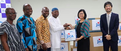 Maki Ozawa, the Senior Representative of JICA, presenting the items to Mahama Asei Seini, a Deputy Minister of Health