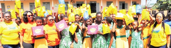 Some girls of the R.C. Girls’ Basic School, Ho, holding their sanitary kits. With them are some of the organisers 