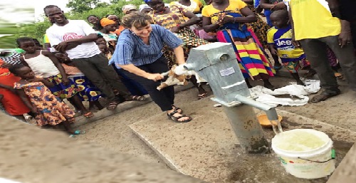 Jana Graves Owen pumping water from one of the completed boreholes at Oyomdo