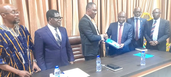 Professor Kwadwo Adinkrah-Appiah (3rd from left), Vice-Chancellor of the Sunyani Technical University, exchanging signed documents with Professor Elvis Asare-Bediako, Vice-Chancellor of UENR, while other officials of the two universities look on