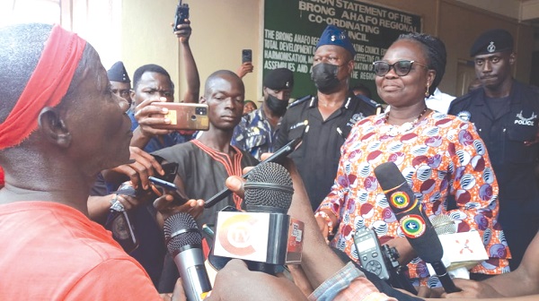 Justina Owusu-Banahene (right), Bono Regional Minister, receiving the petition from Isaac Kumi Boateng (left), the Chairman of the conveners after the peaceful demonstration