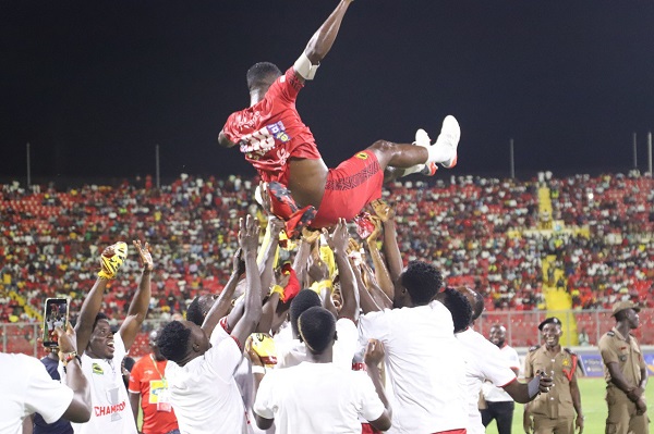 Asante Kotoko players lifting their captain in the air