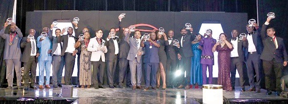 Award winners displaying their award shields at the Ghana Auto Awards in Accra