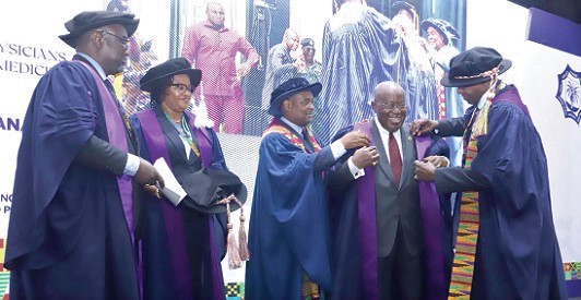 President Akufo-Addo being robed after receiving an Honorary Fellowship from Dr Durodami Radcliffe Lisk (right), President, West African College of Physicians, at the event in Accra. With them are Dr Alfred Edwin Yawson (3rd from left), Vice-Presient, Ghana Chapter; Dr Albert Akpalu (left), Secretary-General, West African College of Physicians, and Dr Enobong Ikpeme (2nd from left), College Treasurer, West African College of Physicians. Picture: SAMUEL TEI ADANO