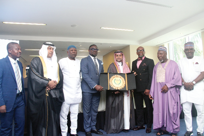 Hani Abu Zaid (4th from right), Chairman/President of the Supreme Council for Arab-African Economy, making a presentation to Dr Humphrey Ayim-Darke (4th  from left), President, Association of Ghana Industries. With them are Haji Mukaila Akuamoah (3rd from right), Chief Executive Officer of the Africa-Arab Investments Hub; Mahama Asei Seini (3rd from left), Deputy Minister of Health, and some  dignitaries. Picture: BENEDICT OBUOBI