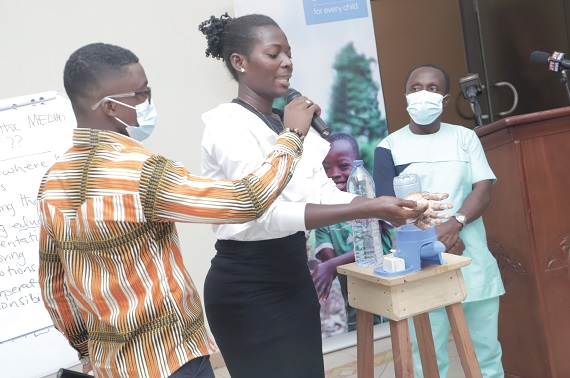 A journalist demonstrating how to properly wash hands during the workshop in Accra. Picture: SAMUEL TEI ADANO