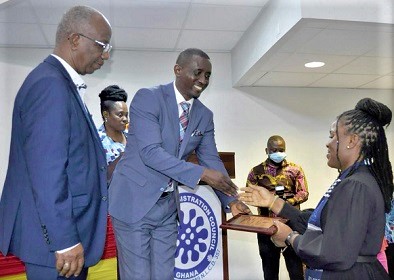 Dr Emmanuel Eyiah-Botwe (middle) and Richard Nii Dadey (left) handing over the Overall Best Student award to Sandra Deladem Woanyah