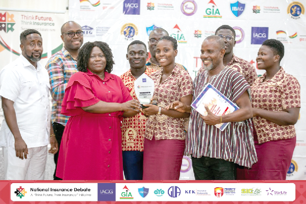 Nicholina Naa Yeye Adumuah (2nd from left), Central Regional Manager of the NIC, presenting the winner’s award to Komenda College of Education