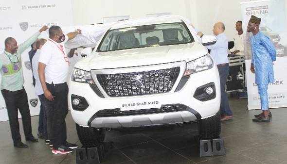  Maurice Quansah (left), Editor of Graphic Sports; Franklin Sowa (2nd from left), Director, Marketing and Sales, GCGL, and Akbar Siddiqi (2nd from right), General Manager, Silver Star Auto, unveiling the Peugeot at the launch of the Graphic World Cup Promo. Pictures: ESTHER ADJORKOR ADJEI