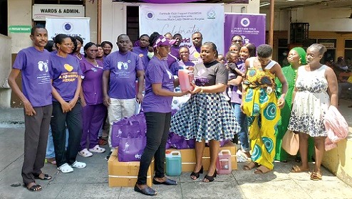 Evelyn Duah (left), Executive Director of the Fortitude Child Support Foundation, presenting the items to Dr Margaret Neizer, Head of Clinical Services at the Princess Marie Louise Children's Hospital in Accra. With them are some members of the foundation and nursing mothers