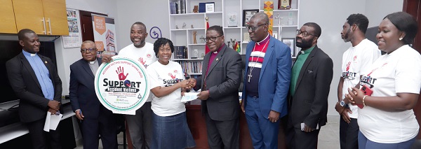Most Rev. Dr Paul Kwabena Boafo (5th from right), Presiding Bishop of the Methodist Church, presenting the cheque for GH¢10,000 to the Accident Victims Support Foundation in Accra. Picture: SAMUEL TEI ADANO