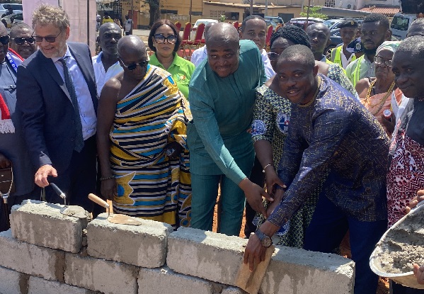 Mr Evans Bobie Opoku (right), Deputy Minister of Youth and Sports is joined by other dignitaries to cut the sod for the construction of the artificial turf in Tema