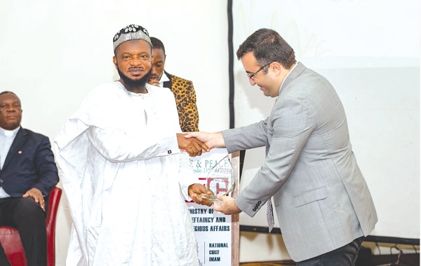 Sheikh Dr Amin Bonsu receiving a  plaque from Mehmet Akmermer, Managing Director, Galaxy International School, at the peace conference