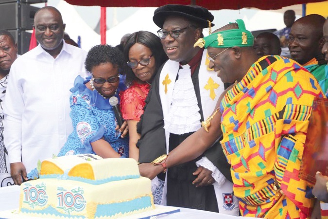  Akyamfour Asafo Boakye Agyemang-Bonsu (in Kente), the Asafohene, being assisted by the Rt Rev. J.O.Y. Mante (2nd right) to cut the centenary anniversary cake. With them are Alan Kyerematen (left), the Minister of Trade and Industry, and Theodosia Jackson (2nd left), Co-Founder, the Jackson Educational Complex. Picture: EMMANUEL BAAH