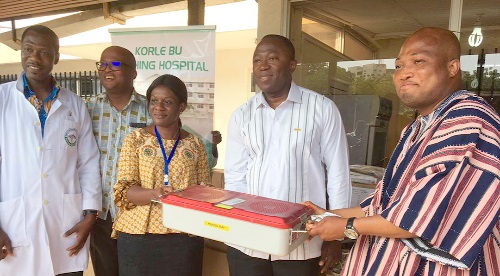 Samuel Okudzeto Ablakwa (right), MP for North Tongu, making a symbolic presentation of the items to Dr Opoku Ware Ampomah (2nd from right), CEO of the KBTH