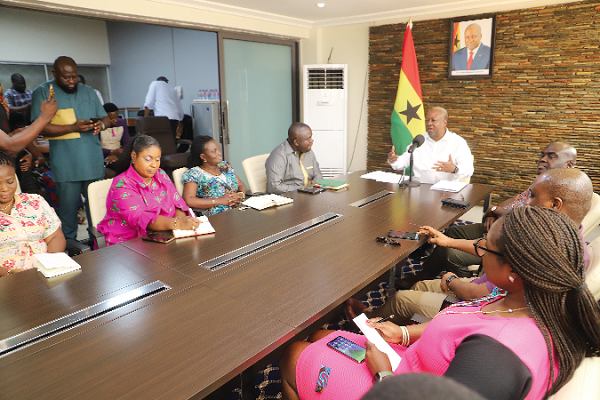 Former President John Mahama (head of table) addressing the GJA  Executive (seated left), during a courtesy call on him at his office in Accra. Those in the picture include some presidential staffers (right). Picture: GABRIEL AHIABOR