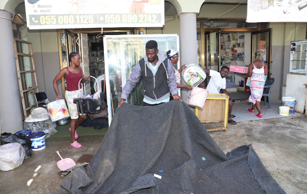 Some shop owners at Tetegu cleaning their shops after the flood