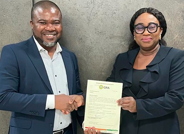  Lawrencia Himans (right), Head of Finance and Planning, and Michael Bozumbil, CEO, PETROSOL, displaying GRA’s congratulatory lette