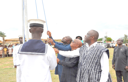 The Deputy Minister for Food and Agriculture responsible for Crops, Yaw Frimpong Addo (in smock), Deputy Minister of Fisheries, Moses Anim, Volta Regional Minister, Dr Archibald Yao Letsa (middle), hoisting the Ghana flag. 