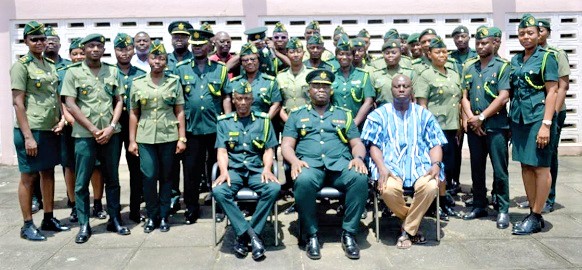 DCOI Faisal Disu (seated middle), Eastern Regional Commander of the Ghana Immigration Service; ACI Justice Amevor (seated right), Assistant Commissioner of Immigration, and ACI Mohammed Hussein Awal (seated left), Deputy Regional Commander of Immigration, with municipal and district commanders of the service