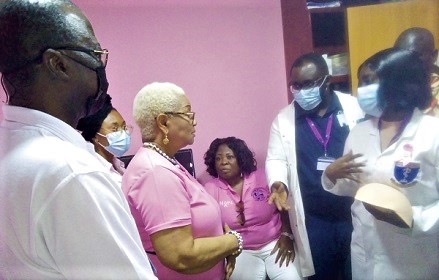 Ampomaa Ofosu-Otchere (right), a radiographer of the VRA Hospital, explaining the use of a mammogram machine to Emmanuel Antwi-Darkwa (left), CEO of the VRA, and Joyce Rosalind Aryee (2nd from left), Board Chairperson, after the commissioning of the machines.