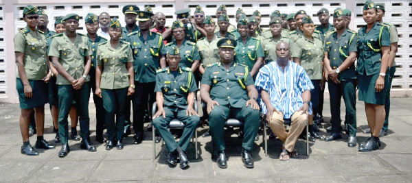 DCOI Faisal Disu (seated middle), Eastern Regional Commander of the Ghana Immigration Service; ACI Justice Amevor (seated right), Assistant Commissioner of Immigration, and ACI Mohammed Hussein Awal (seated left), Deputy Regional Commander of Immigration, with municipal and district commanders of the service