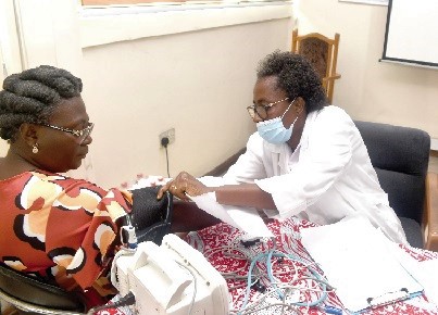  Lydia Siaw-Lartey (right), a Senior Nursing Officer at the Graphic Clinic, checking the blood pressure of a GCGL staff member. Picture: ESTHER ADJORKOR ADJEI