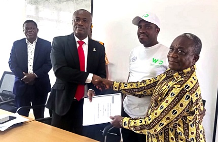 Prof. Gabriel Dwomoh (second left), Pro Vice-Chancellor of KsTU exchanging the documents with John Nimoh (right) the National Secretary of the Ghana National Association of Garages