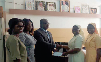  Dwomoh-Ameyaw (3rd from left) presenting the cheque to Theresa Authur