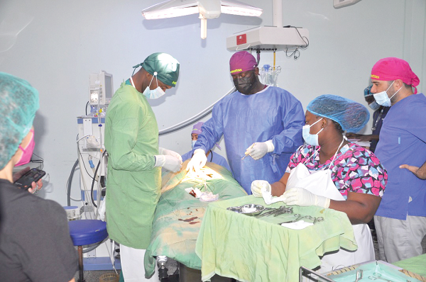 Dr Obeng (2nd from left) and other members of RESTORE carrying out reconstructive surgery on a patient
