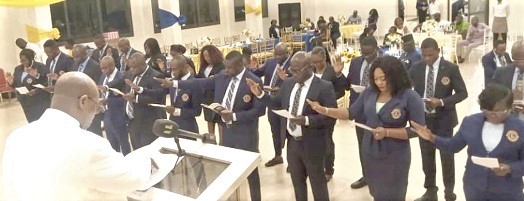 Emmanuel Kojo Gyimah (left), District Governor, District 418 Ghana of the Lions Club International, swearing in members of the newly formed  Tema Industrial Lions Club. Picture: BENJAMIN XORNAM GLOVER 