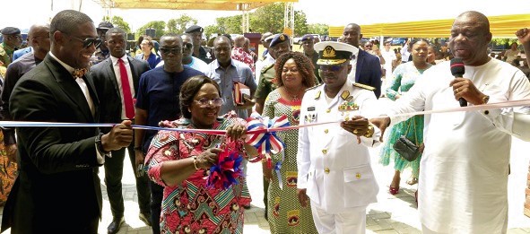 Akosua Frema Osei-Opare (2nd from left), Chief of Staff, being assisted by Dr Okoe Boye (left), Vice Admiral Amoama (2nd from right), and Bishop Isaac Quaye to inaugurate the building
