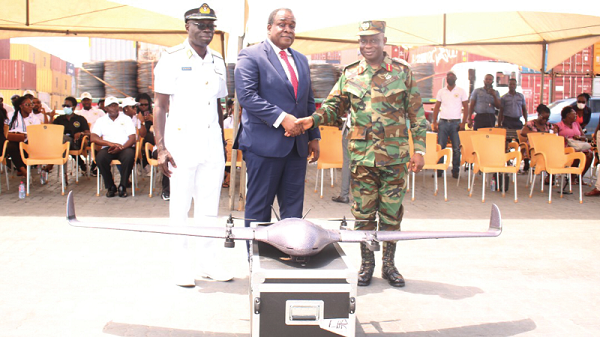One of the drones being tested. INSET: Benjamin Acolatse (middle) presenting a drone to Major General Dr Emmanuel Kotia (right) while Commodore Emmanuel Kwafo looks on