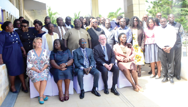 Justice Kwabena Asuman Edu (seated middle), Chairman, National Labour Commission, with some officials and participants in the workshop