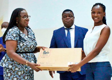 Prof. Nana Aba Appiah Amfo (left), Vice-Chancellor of the University of Ghana, presenting a laptop to one of the beneficiaries