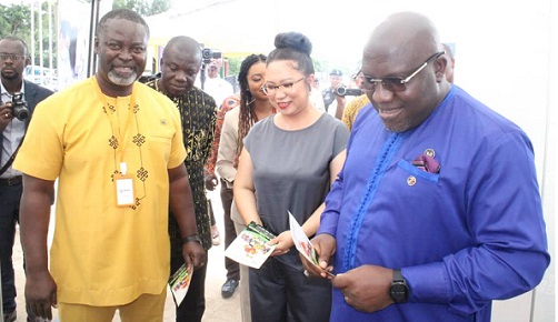 Mr Seth Kwame Acheampong (right), The Eastern Regional Minister, Madam Lisa Hao (middle), Chairperson of TIAST Group, and Mr Isaac Appau-Gyasi, the Municipal Chief Executive of New Juaben South at one of the exhibition stands.