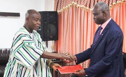 Prof Gabriel Ayum Teye (left), outgoing Vice-Chancellor, presenting the handing over notes to Prof Seidu Alhassan (right), the new Vice-Chancellor