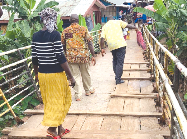 Some pedestrians using the footbridge at the Race Course Market in Kumasi