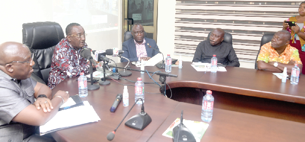 Dr Owusu Afriyie Akoto (2nd from left), Minister of Food and Agriculture, speaking at the launch of the National Farmers Day in Accra. With him is Seth Kwame Acheampong (left), Eastern Regional Minister, and other  dignitaries.