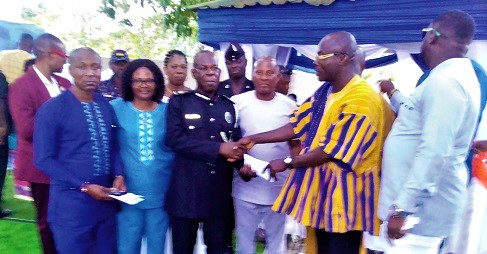 Richmond Amponsah Agyabeng (right), presenting the citation to DCOP Adikah. Also with them is Victoria Adu (2nd from left), the Birim Central DCE
